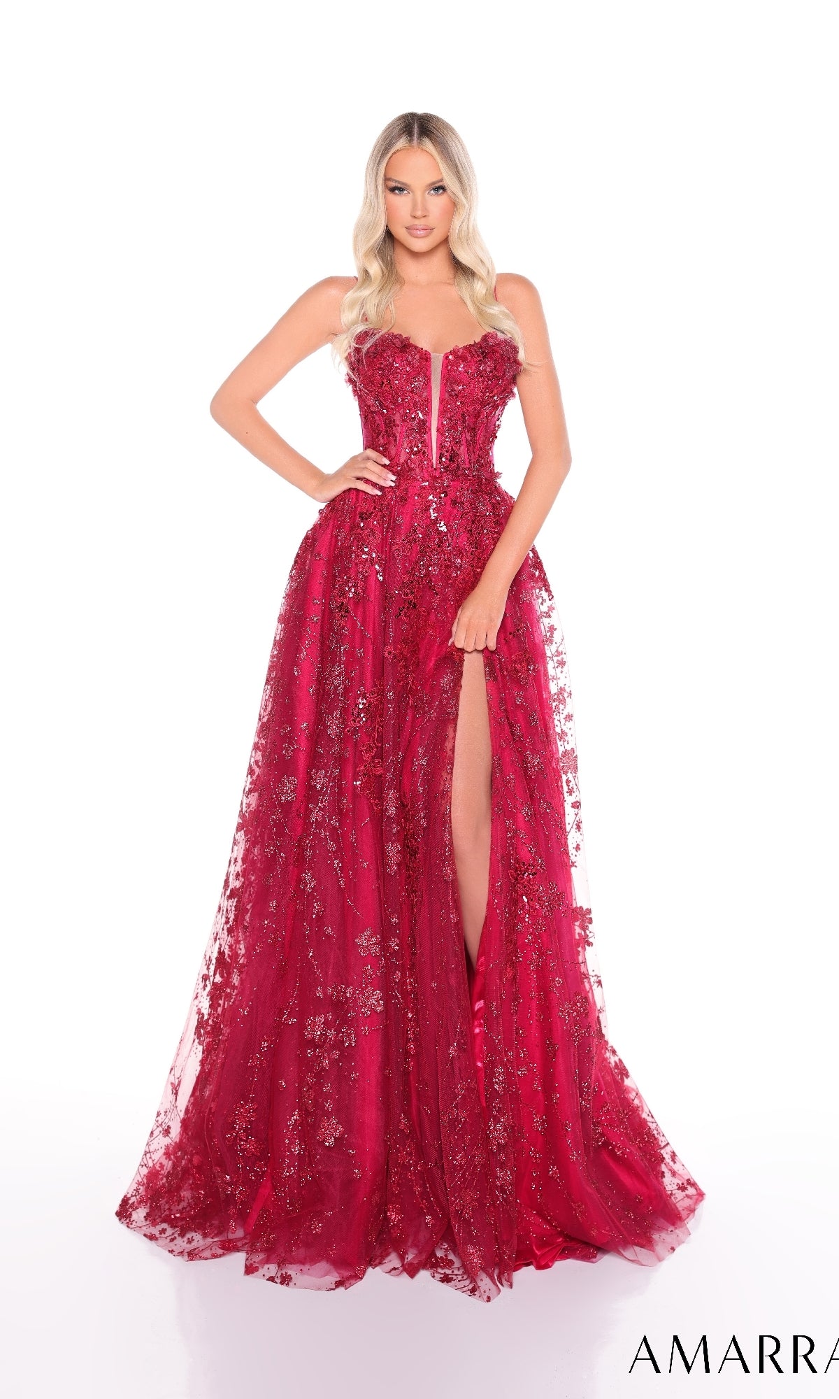 A woman wearing the Amarra 88315 long prom dress, a strapless red A-line gown with 3D floral appliques and a thigh-high slit, stands against a white background.